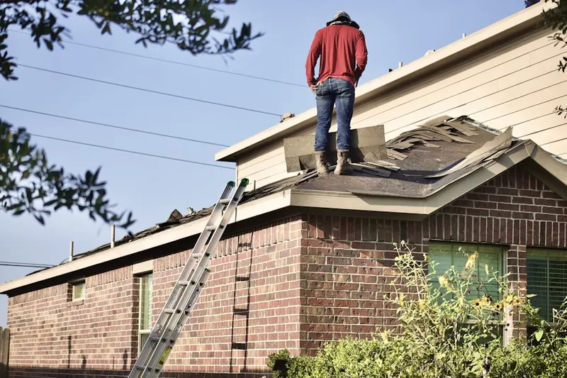 Professional roofer working on a residential roof in Pine Springs